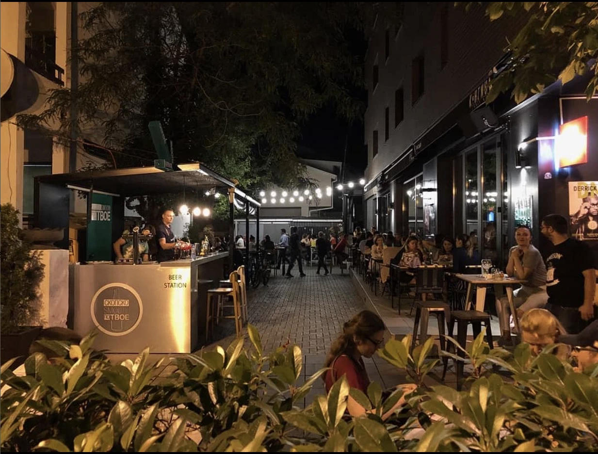 Kantina restaurant at night, with patio seating, string lights, and a busy crowd